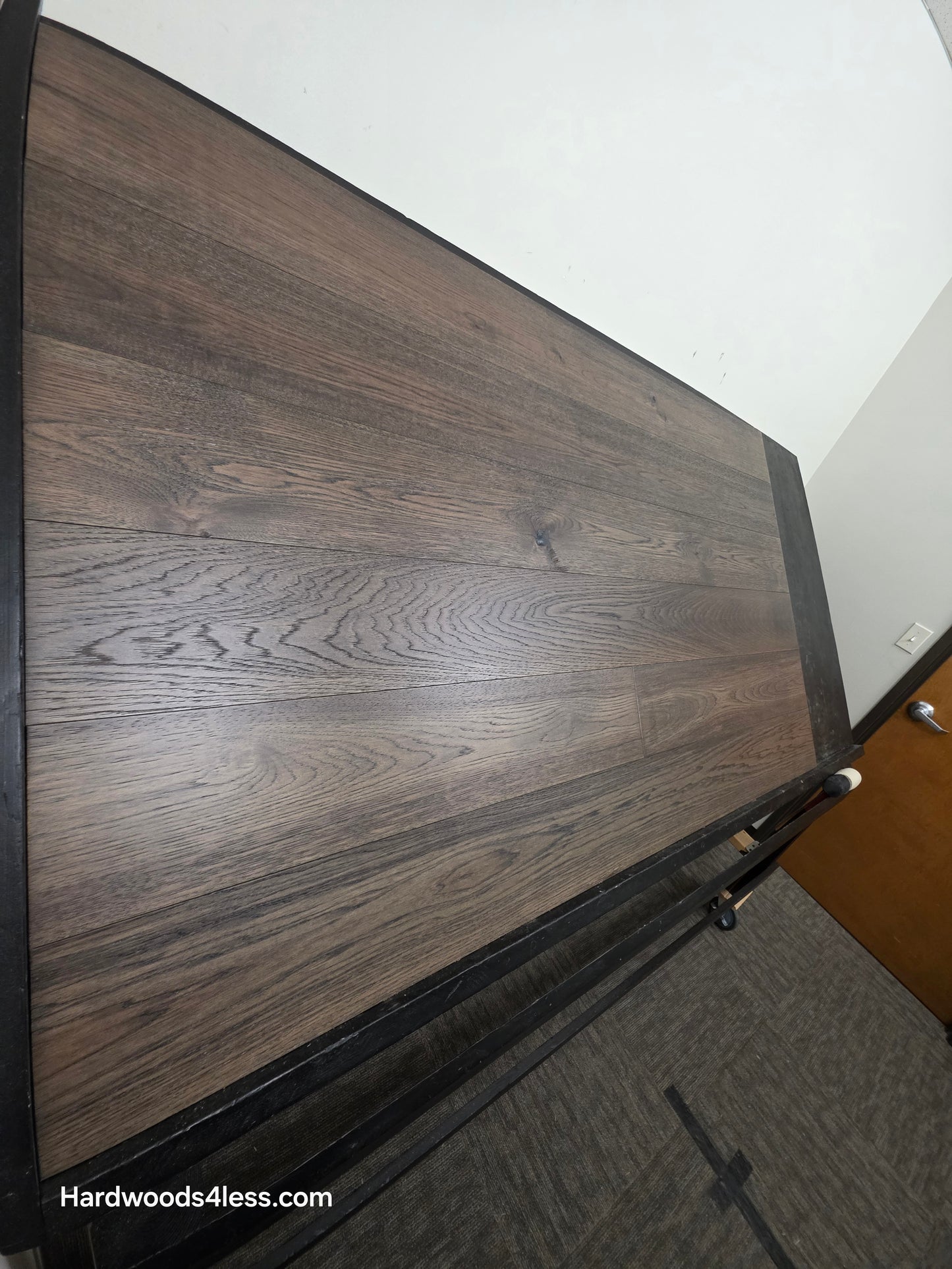  7 1/2" x 9/16" Engineered Hickory Quarry Hardwood Flooring. Shown on a black shooting table. Shot very close up steep left. 