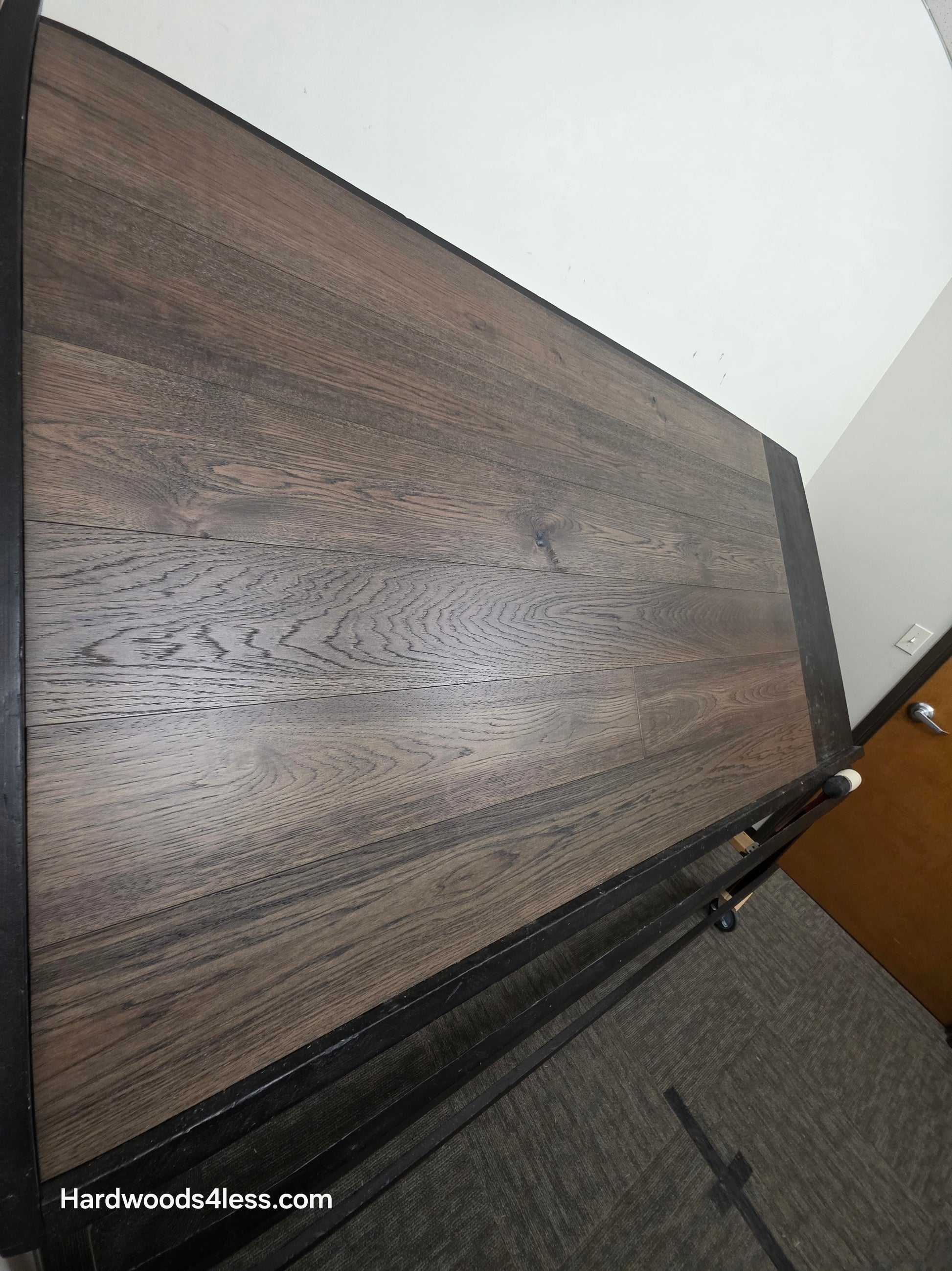 7 1/2" x 9/16" Engineered Hickory Quarry Hardwood Flooring. Shown on a black shooting table. Shot very close up steep left. 