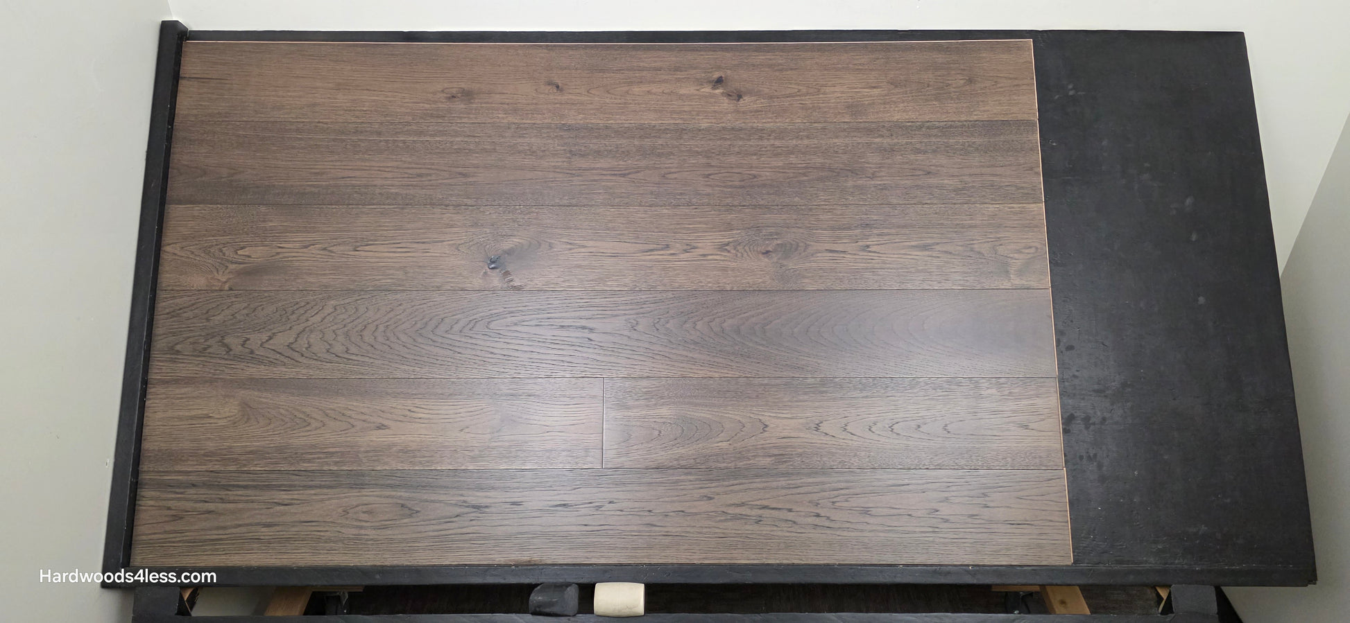 7 1/2" x 9/16" Engineered Hickory Quarry Hardwood Flooring. Shown on a black shooting table. shot from the center.