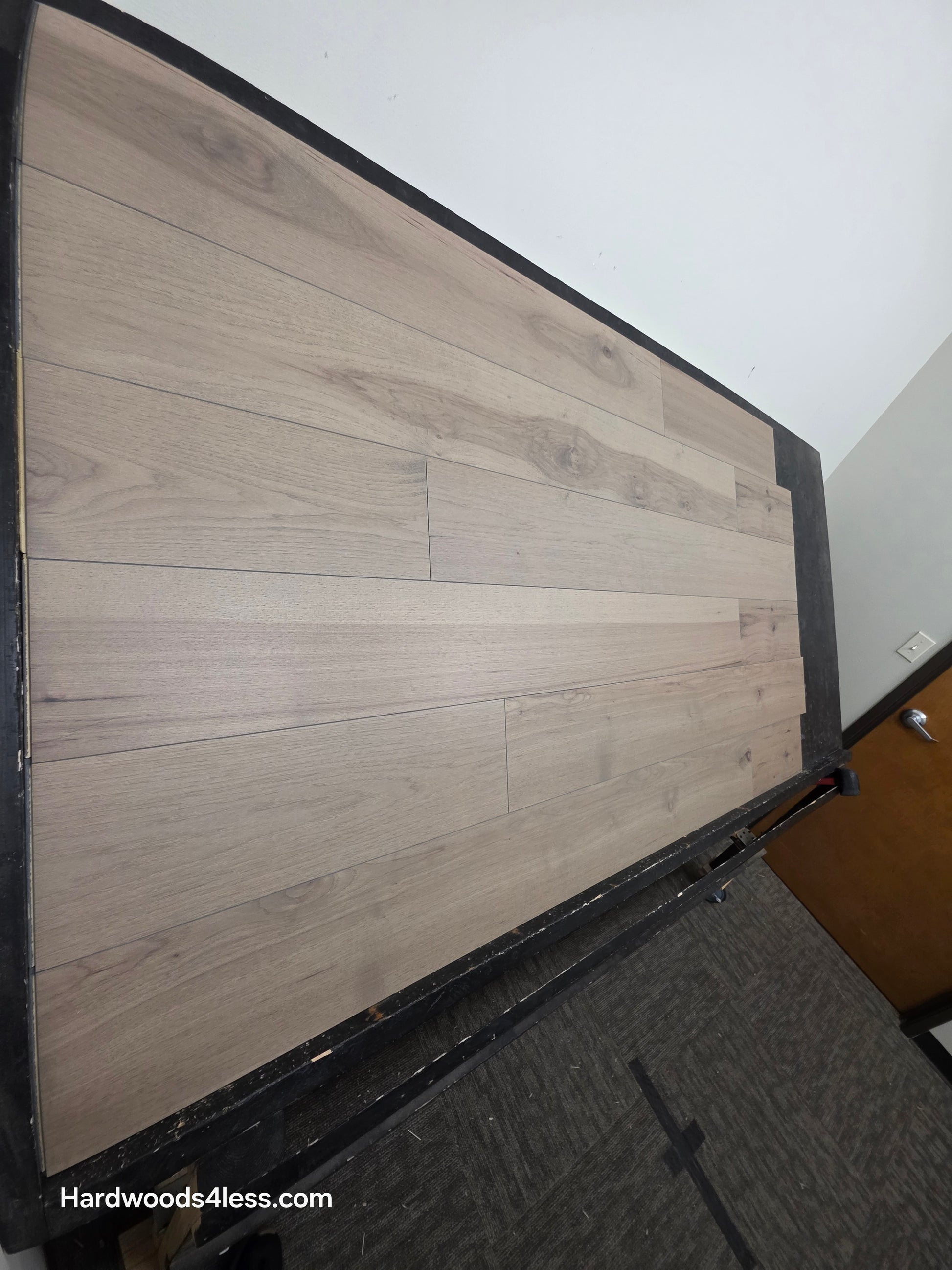 7 3/8" x 1/2" Engineered Hickory Fort Concho Hardwood Flooring. Shown on a black shooting table. shot from steep left. 