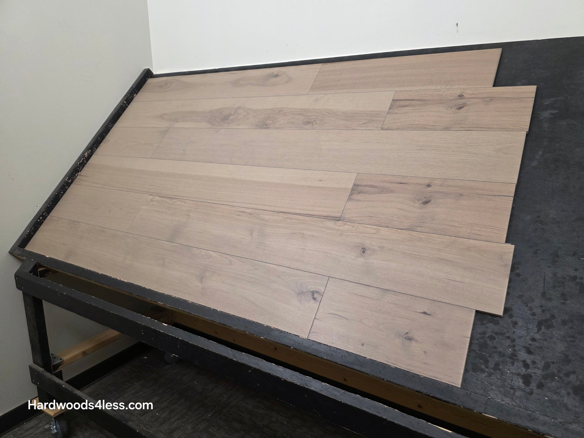 7 3/8" x 1/2" Engineered Hickory Fort Concho Hardwood Flooring. Shown on a black shooting table. shot from wide right.