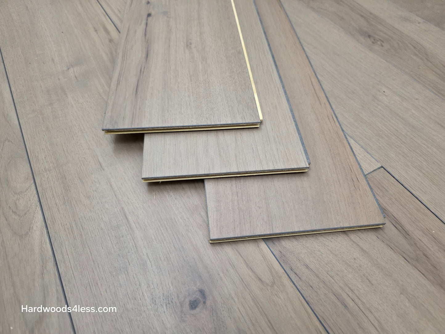 7 3/8" x 1/2" Engineered Hickory Fort Concho Hardwood Flooring. Shown as three boards stacked on the floor. 