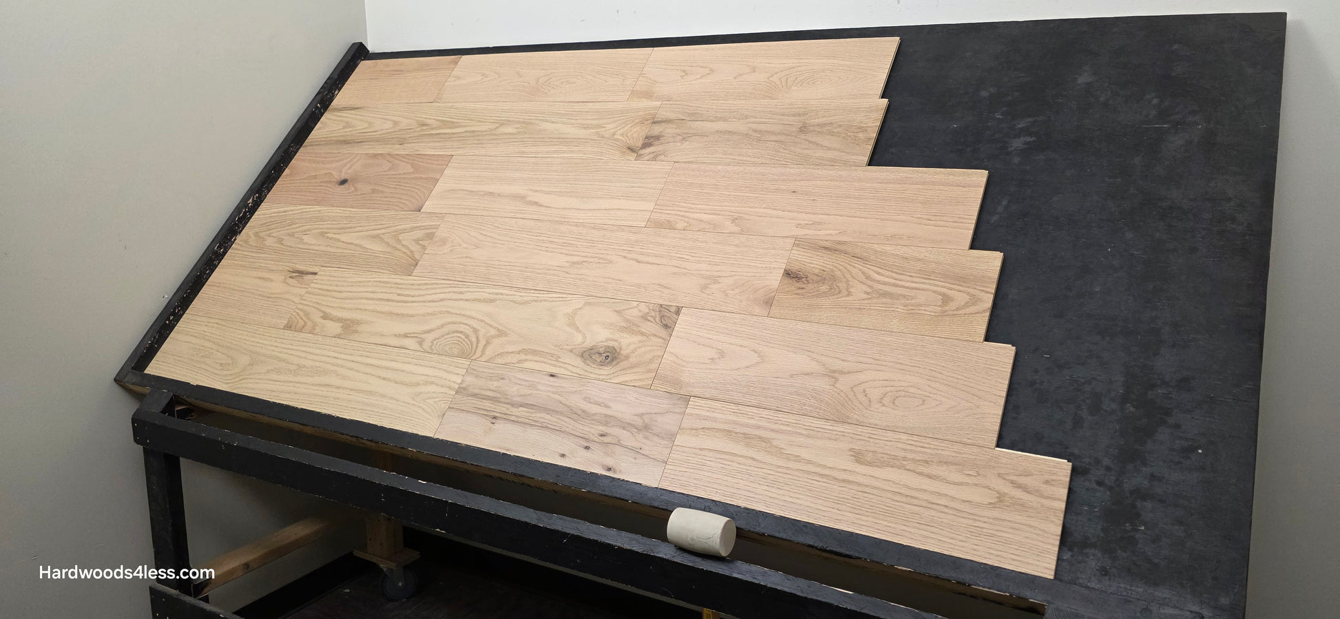 7 3/8" x 1/2" Engineered Red Oak San Bernard Hardwood Flooring. Shown on a black shooting table. wide right hand shot. 