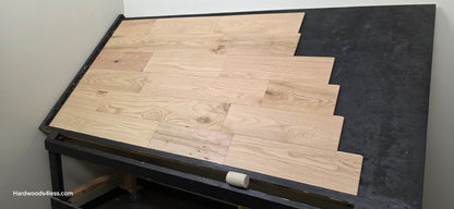 7 3/8" x 1/2" Engineered Red Oak San Bernard Hardwood Flooring. Shown on a black shooting table. wide right hand shot. 