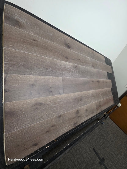 7 3/8" x 1/2" Engineered White Oak Sedona Hardwood Flooring. Shown on a  black shooting table. Steep left hand shot. 