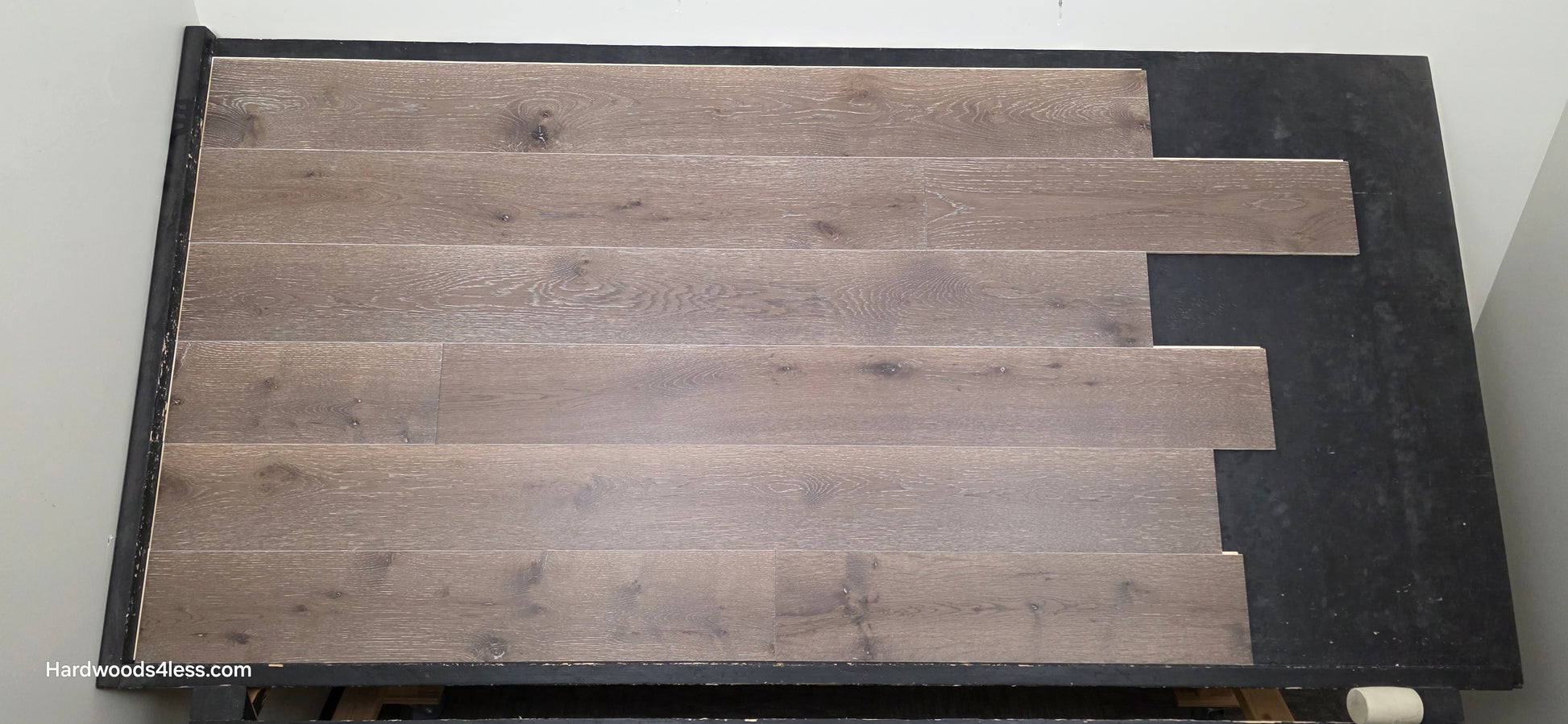 7 3/8" x 1/2" Engineered White Oak Sedona Hardwood Flooring. Shown on a  black shooting table. Center Shot.