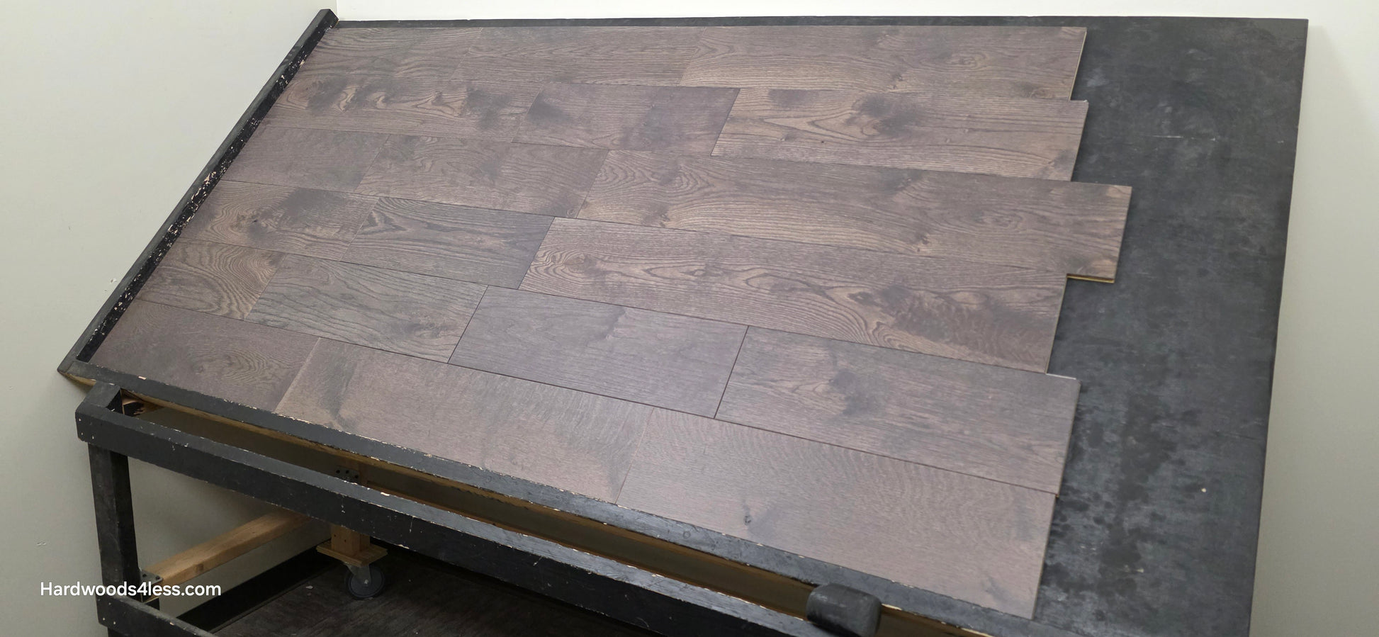 7 3/8" x 5/8" Engineered White Oak Toasted Cocoa Hardwood Flooring. Shown on a black shooting table shot from right side.