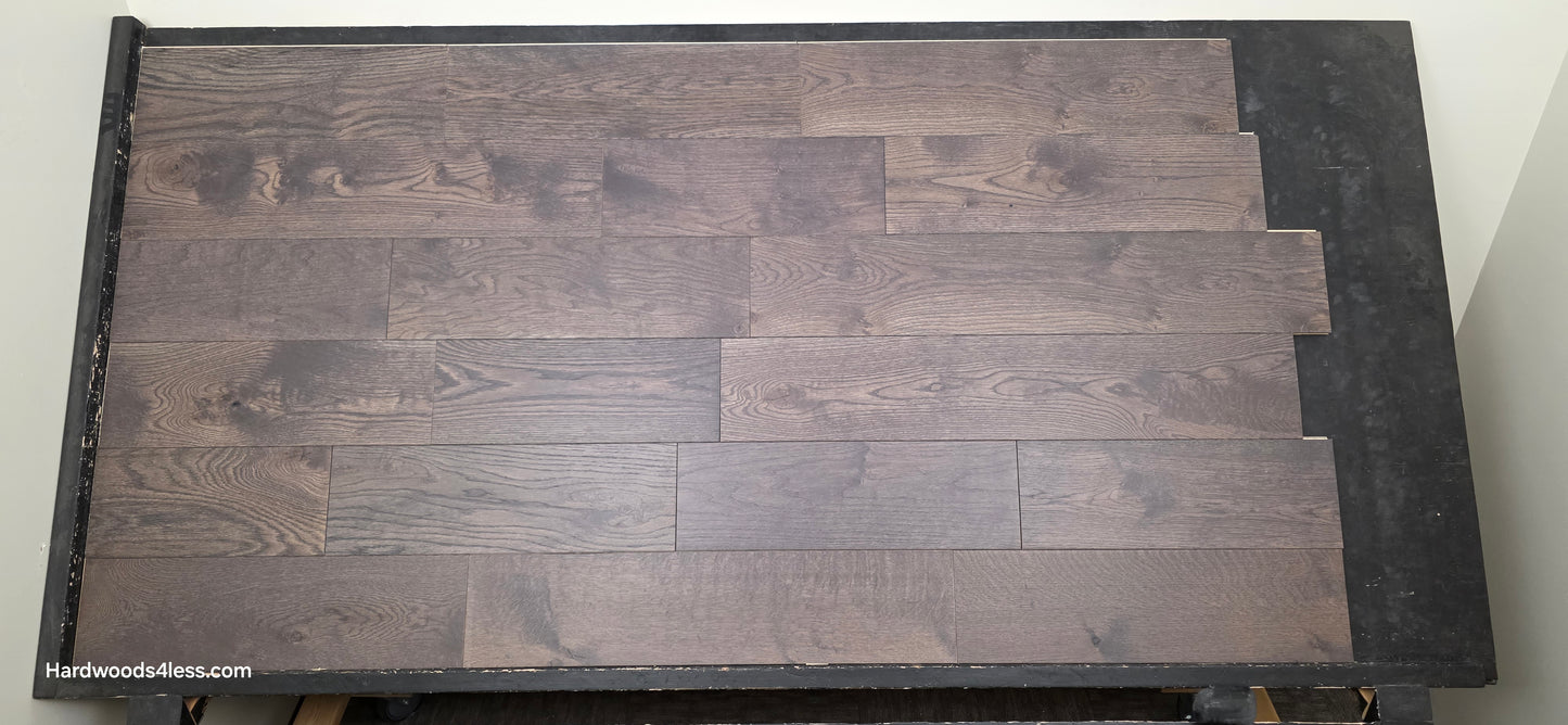 7 3/8" x 5/8" Engineered White Oak Toasted Cocoa Hardwood Flooring. Shown on a black shooting table. Shot at center.