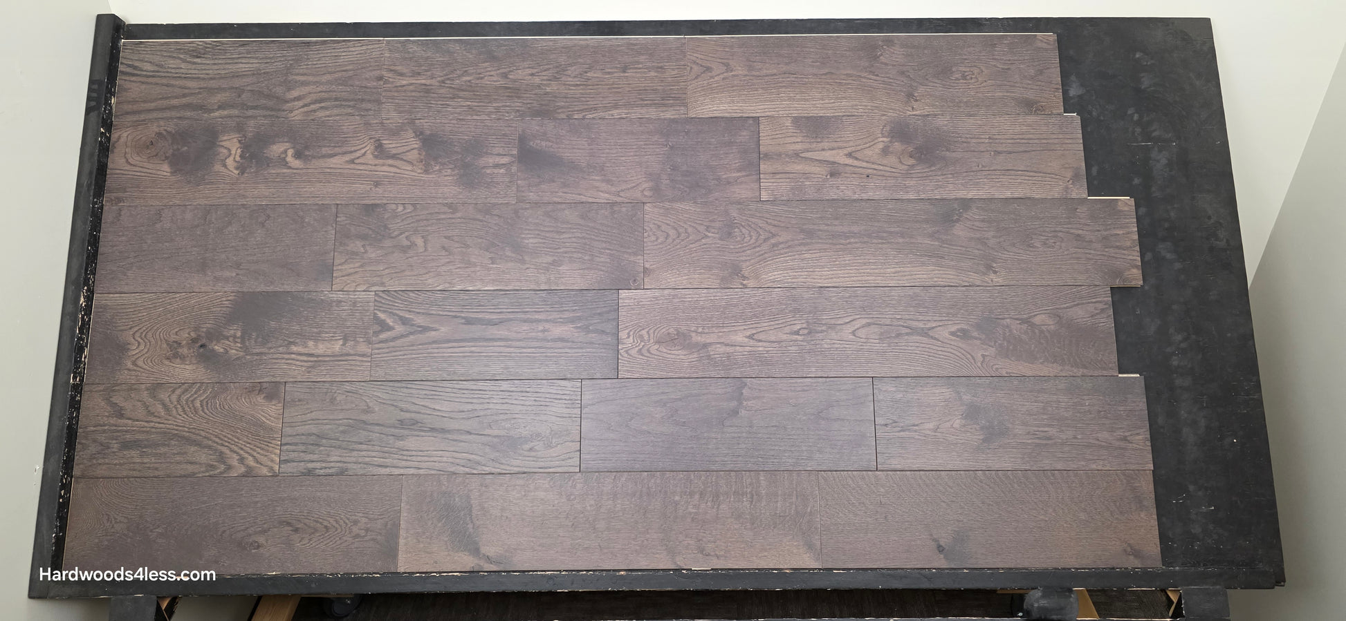 7 3/8" x 5/8" Engineered White Oak Toasted Cocoa Hardwood Flooring. Shown on a black shooting table. Shot at center.
