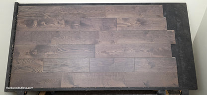 7 3/8" x 5/8" Engineered White Oak Toasted Cocoa Hardwood Flooring. Shown on a black shooting table. Shot at center.