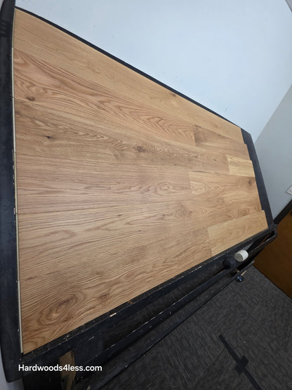 7" x 1/2" Engineered White Oak Natural Hardwood Flooring. Shown on a black shooting table. Shot from steep left.