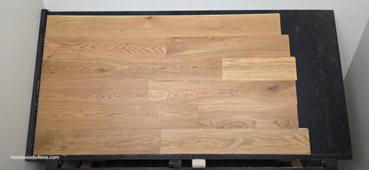 7" x 1/2" Engineered White Oak Natural Hardwood Flooring. Shown on a black shooting table. Shot from center.