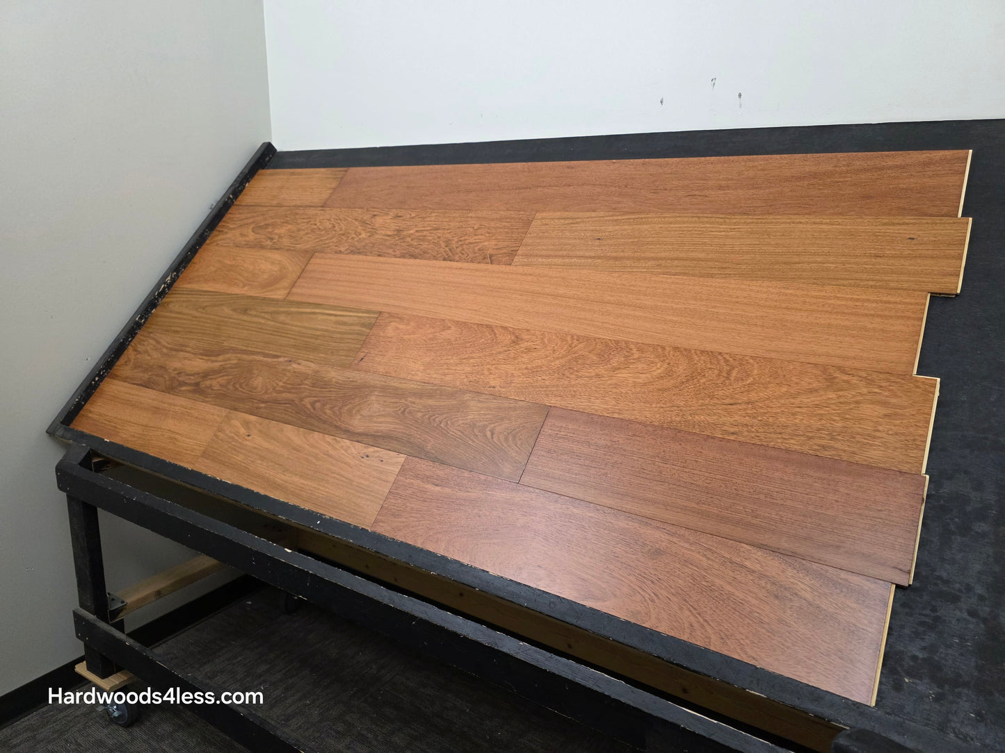 7" x 9/16" Engineered Brazilian Cherry Hardwood Flooring. Shown on a black shooting table. Shot from wide right.