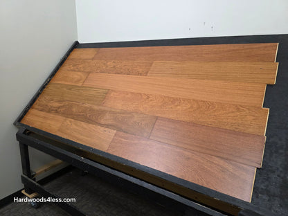 7" x 9/16" Engineered Brazilian Cherry Hardwood Flooring. Shown on a black shooting table. Shot from wide right.