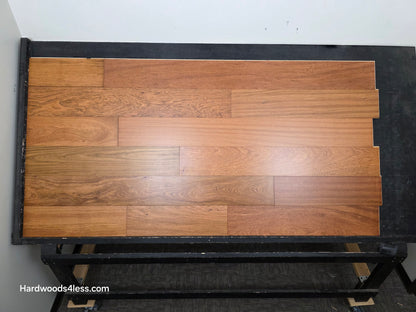 7" x 9/16" Engineered Brazilian Cherry Hardwood Flooring. Shown on a black shooting table. Shot from Center. 