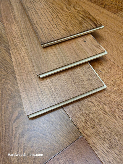 7" x 9/16" Engineered Brazilian Cherry Hardwood Flooring. Shown as 3 planks stacked on top of the floor. 