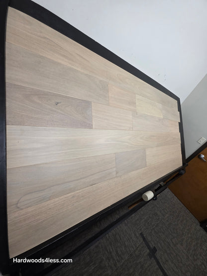 7" x 9/16" Engineered Brazilian Oak Mist Hardwood Flooring. shown on a black shooting table. Shot from steep left. 
