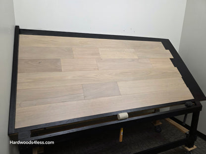 7" x 9/16" Engineered Brazilian Oak Mist Hardwood Flooring. Shown on a black shooting table. Shot from wide left. 