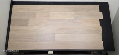 7" x 9/16" Engineered Brazilian Oak Mist Hardwood Flooring. Shown on a black shooting table. Shot from center.