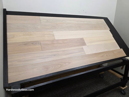 7 x 916 Engineered Brazilian Oak Pearl Hardwood Flooring. Shown on a black shooting table. Shot from wide left.