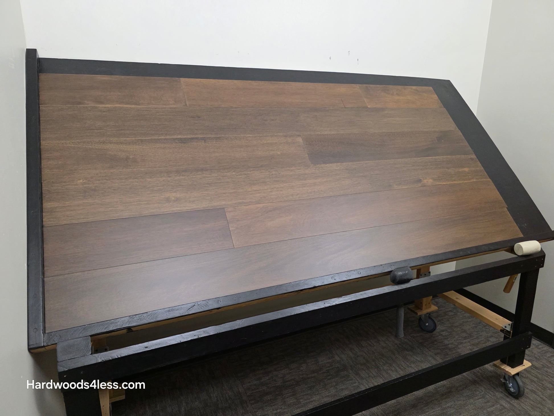 7" x 9/16" Engineered Brazilian Oak Pebble Hardwood Flooring. Shown on a black shooting table. Shot from wide left.