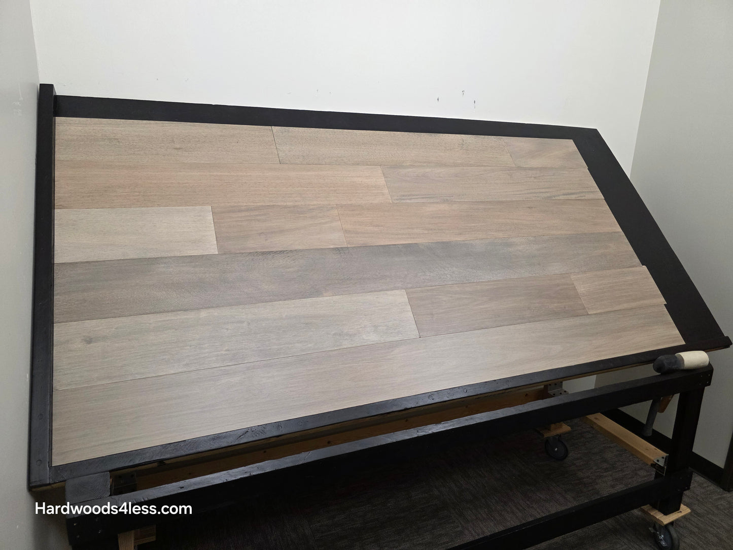 7" x 9/16" Engineered Brazilian Oak Pyrite Hardwood Flooring. Shown on a black shooting table. Shot from the left side.