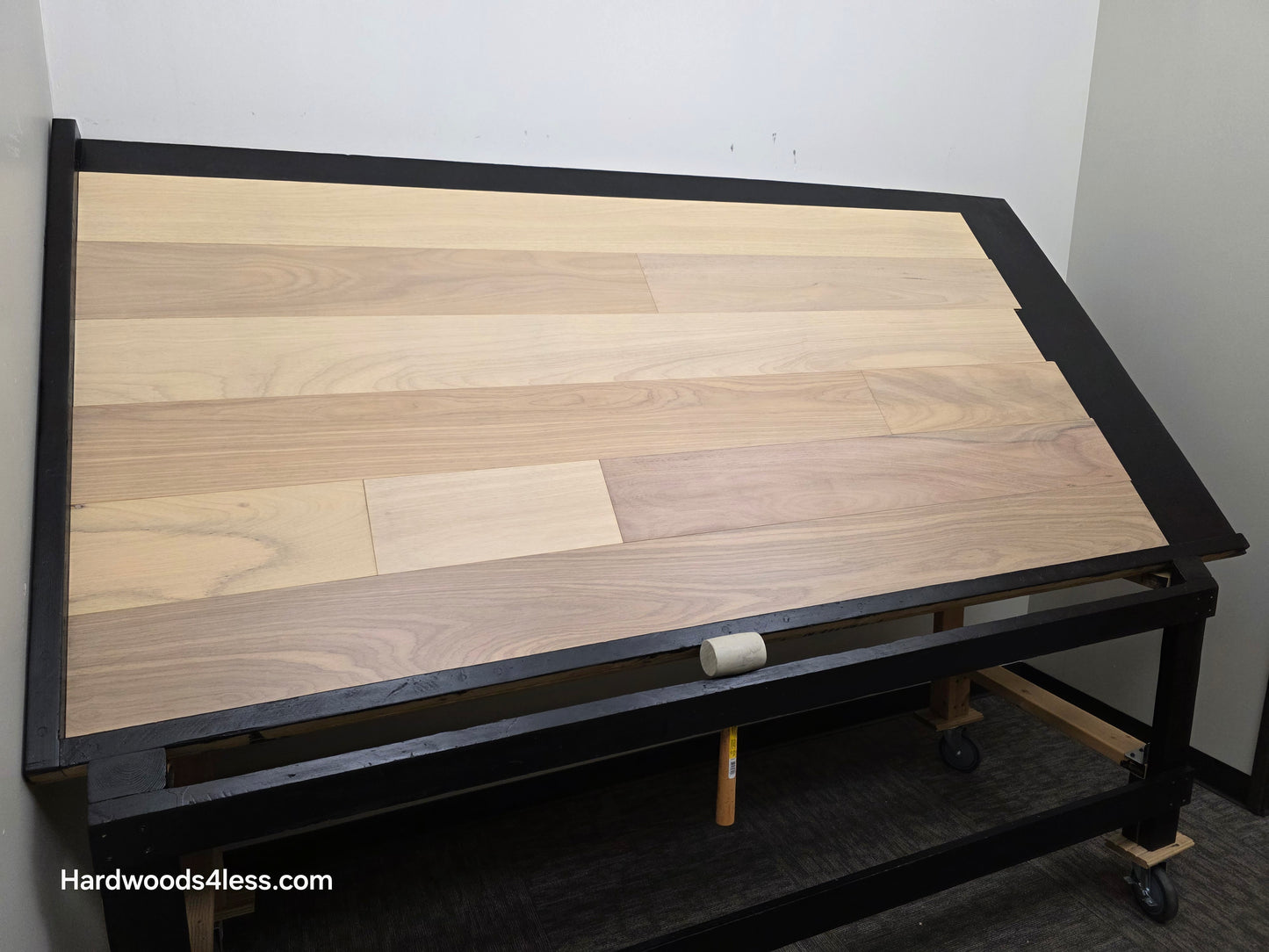 7" x 9/16" Engineered Brazilian Oak Sandy Empire Hardwood Flooring. Shown on a black shooting table. Shot from wide left.