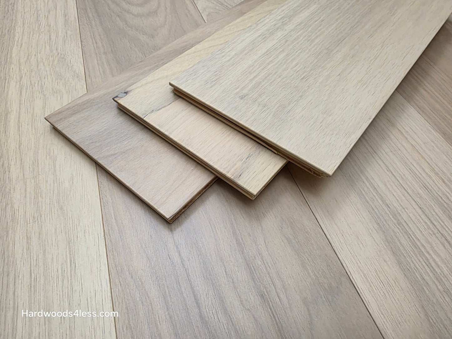 7" x 9/16" Engineered Brazilian Oak Sandy Empire Hardwood Flooring. Shown as 3 tiles stacked on top of the floor. 