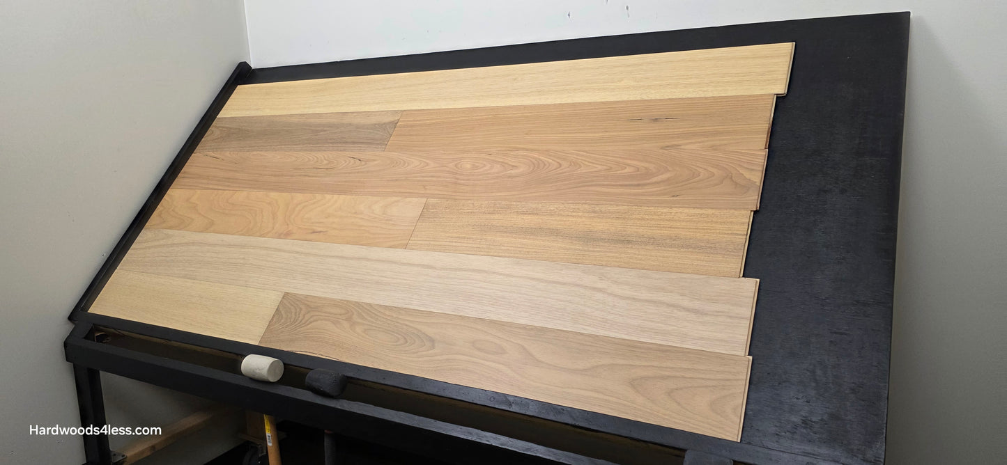 7" x 9/16" Engineered Brazilian Oak Sunlight Hardwood Flooring. Shown on a black shooting table. Shot from wide right.