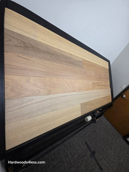 7" x 9/16" Engineered Brazilian Oak Sunlight Hardwood Flooring. Shown on a black shooting table. Shot from steep left.