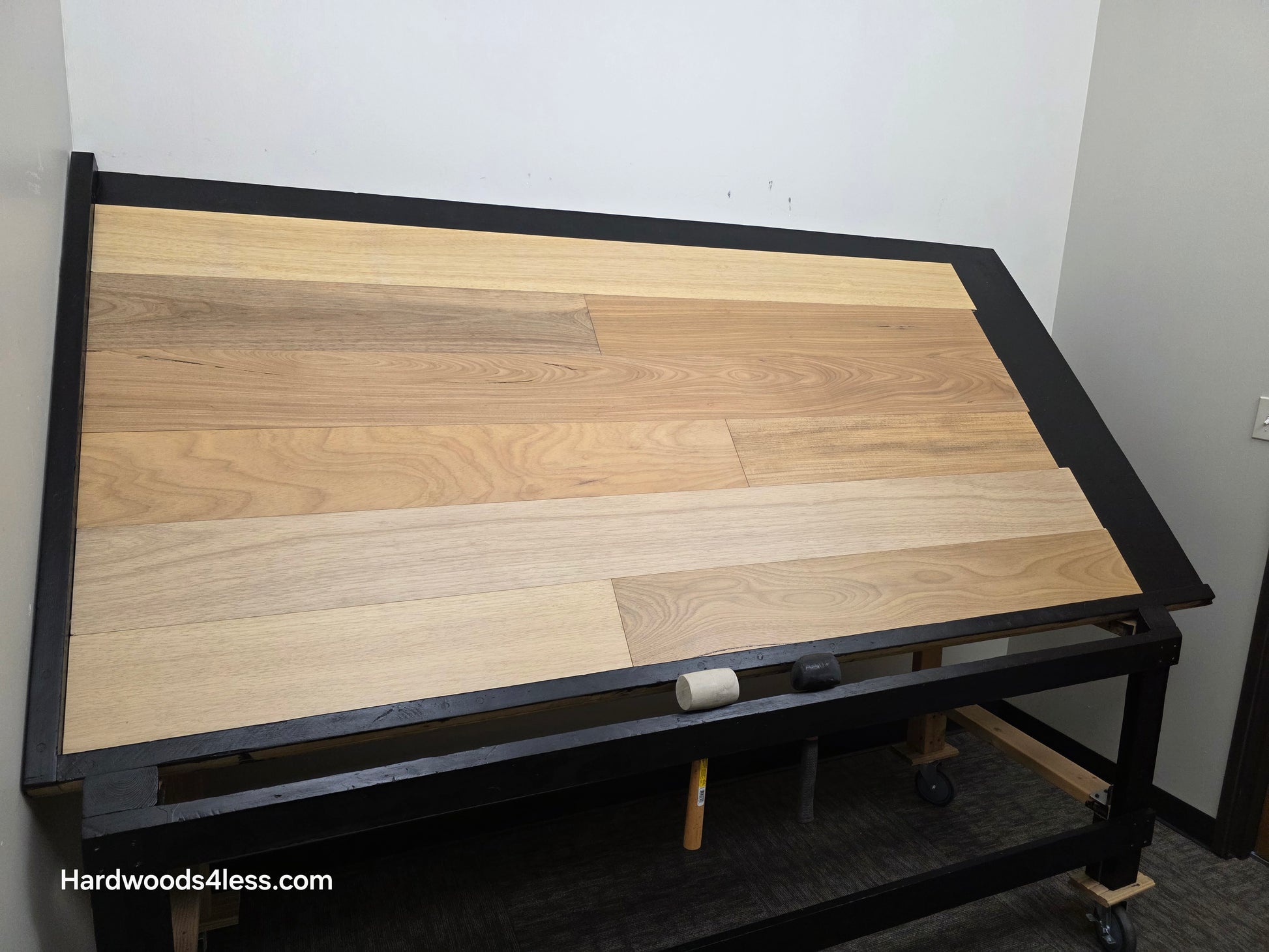 7" x 9/16" Engineered Brazilian Oak Sunlight Hardwood Flooring. Shown on a black shooting table. Shot from wide left.