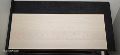 8.11" x 7/16" Modernized Engineered Ash Corbusier Hardened Hardwood Flooring. Shown on a black shooting table. Shot from center.