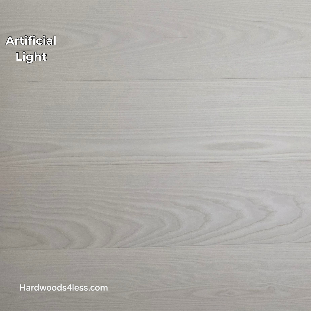 8.11" x 7/16" Modernized Engineered Ash Corbusier Hardened Hardwood Flooring. Shown  in artificial lighting.