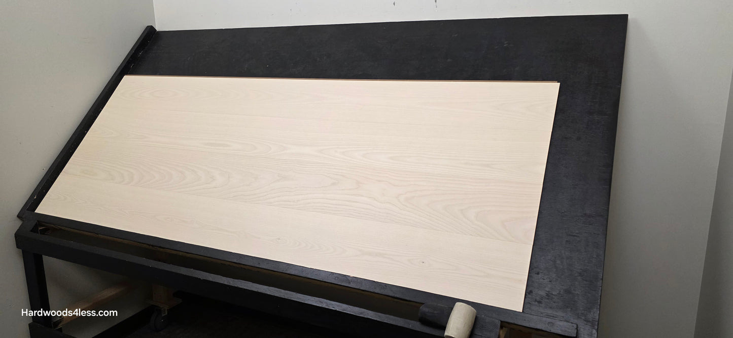 8.11" x 7/16" Modernized Engineered Ash Corbusier Hardened Hardwood Flooring. Shown on a black shooting table. Shot from wide right.