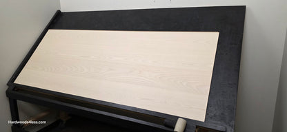8.11" x 7/16" Modernized Engineered Ash Corbusier Hardened Hardwood Flooring. Shown on a black shooting table. Shot from wide right.
