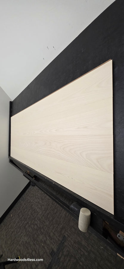 8.11" x 7/16" Modernized Engineered Ash Corbusier Hardened Hardwood Flooring. Shown on a black shooting table. Shot from steep right.