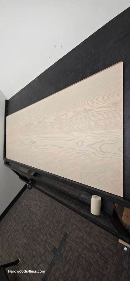 8.11" x 7/16" Modernized Engineered Ash Foster Hardened Hardwood Flooring. Shown on a black shooting table. Shot from steep right.