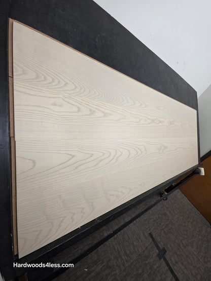 8.11" x 7/16" Modernized Engineered Ash Foster Hardened Hardwood Flooring. Shown on a black shooting table. Shot from steep left. 