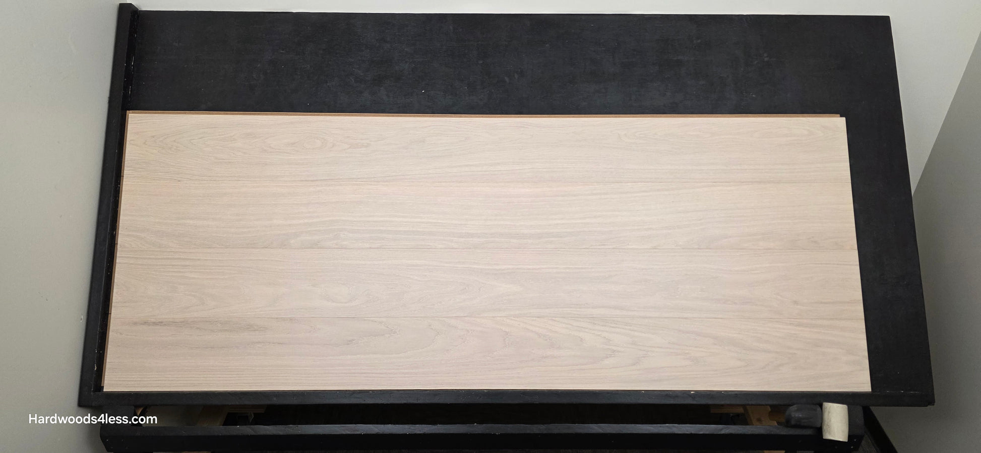 8.11 x 716 Modernized Engineered European Oak Corbusier hardened Hardwood Flooring. Shown on a black shooting table. Shot from center.