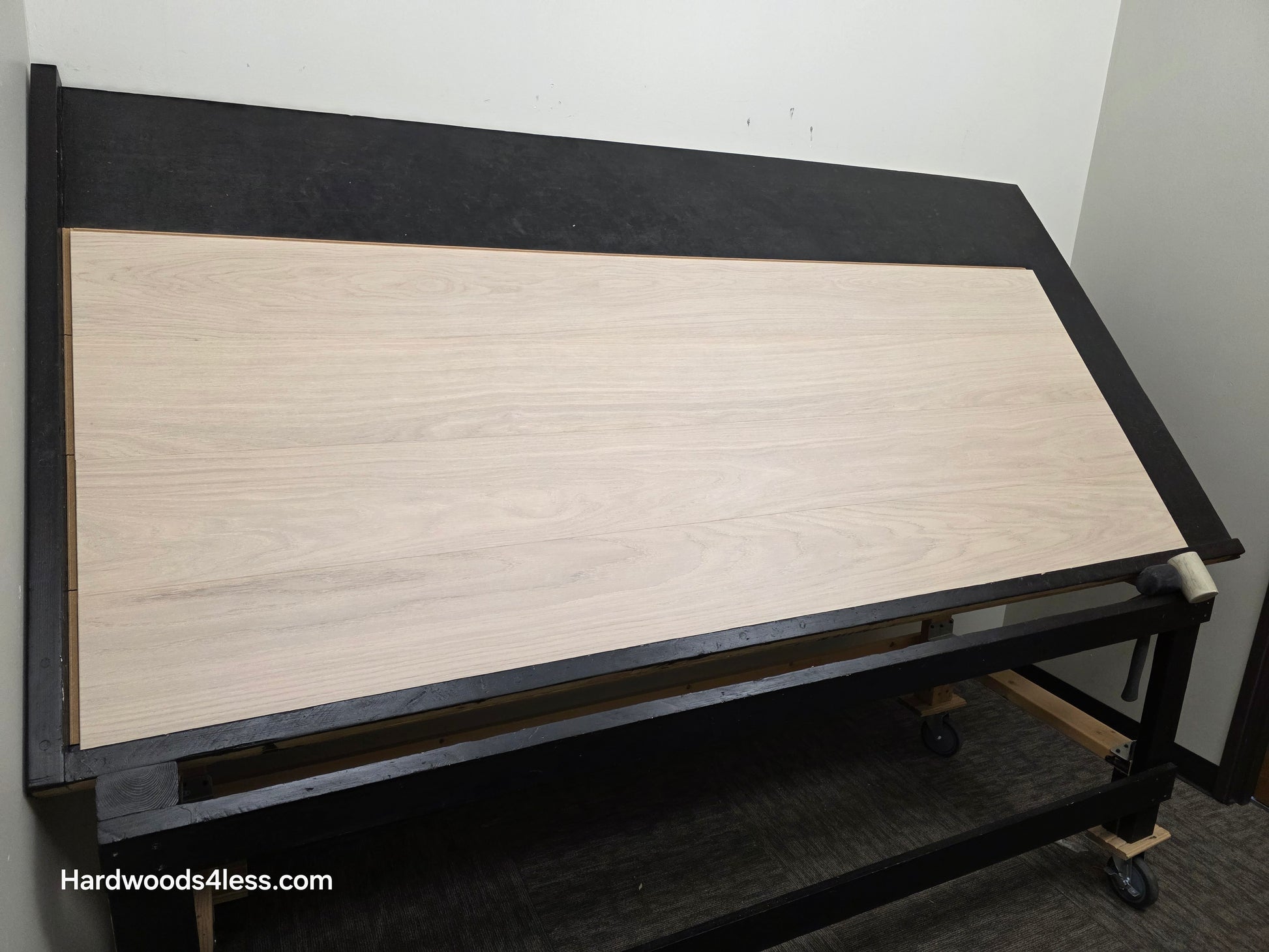 8.11 x 716 Modernized Engineered European Oak Corbusier hardened Hardwood Flooring. Shown on a black shooting table. Shot from wide left.