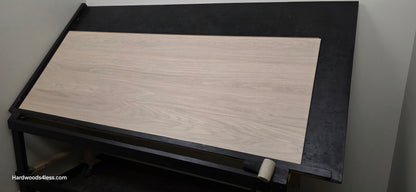 8.11 x 716 Modernized Engineered European Oak Corbusier hardened Hardwood Flooring. Shown on a black shooting table. Shot from wide right. Darkened to show the grain.