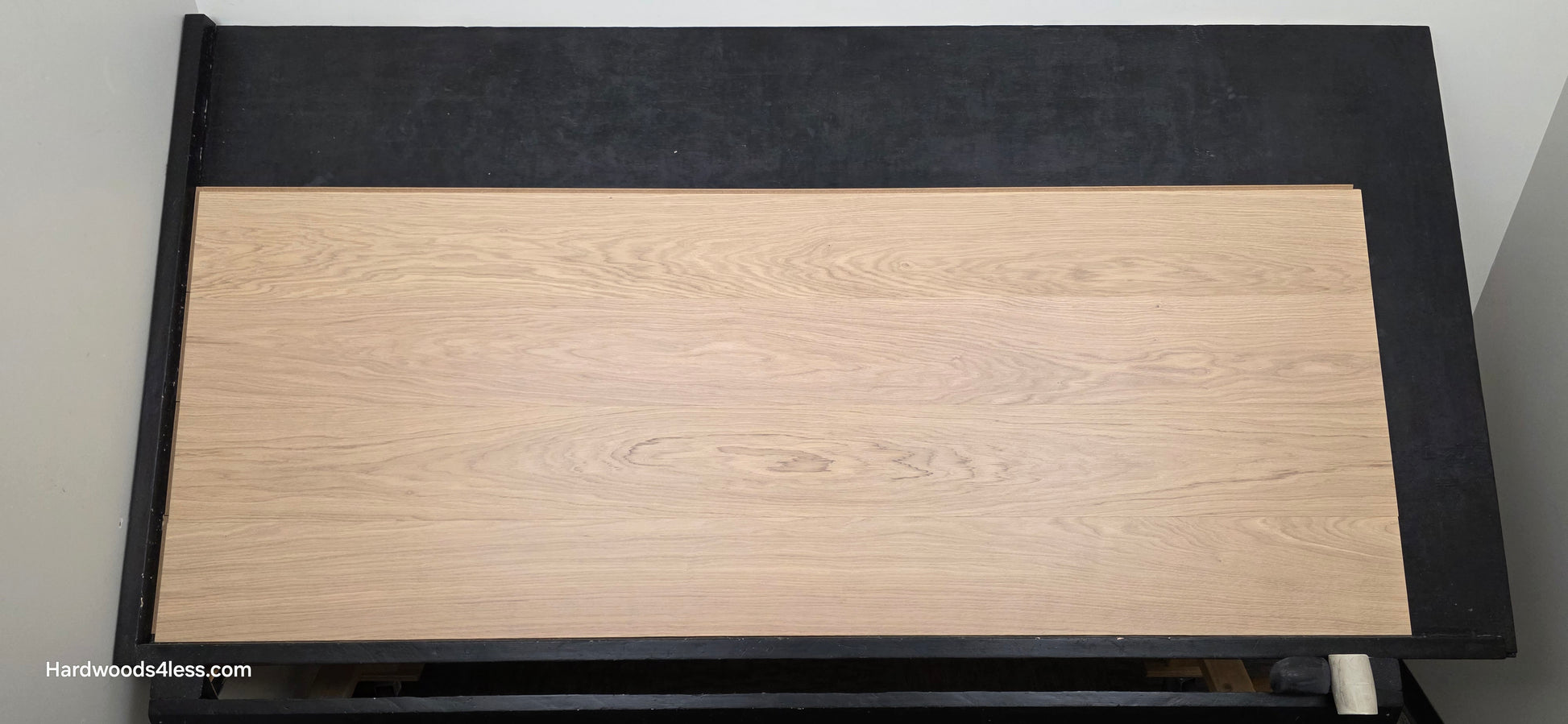 8.11" x 7/16" Modernized Engineered European Oak Gropius Hardened Hardwood Flooring. Shown on a black shooting table. Shot from center.