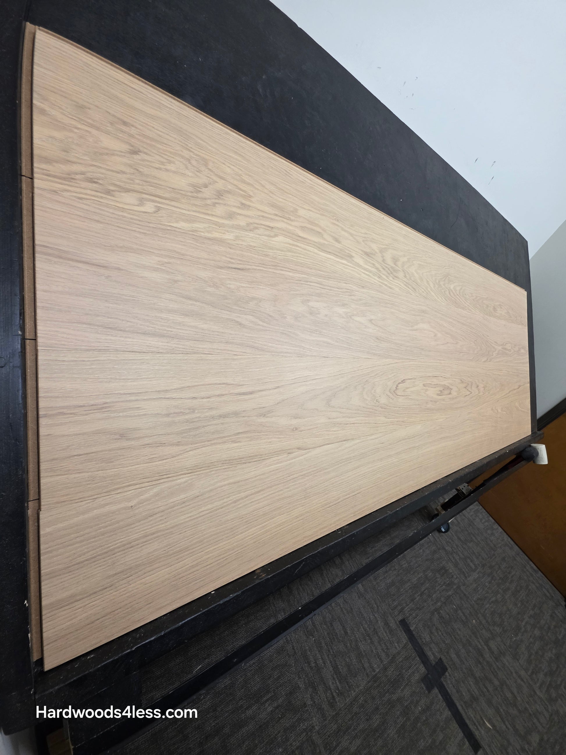 8.11" x 7/16" Modernized Engineered European Oak Gropius Hardened Hardwood Flooring. Shown on a black shooting table. Shot from steep left. 
