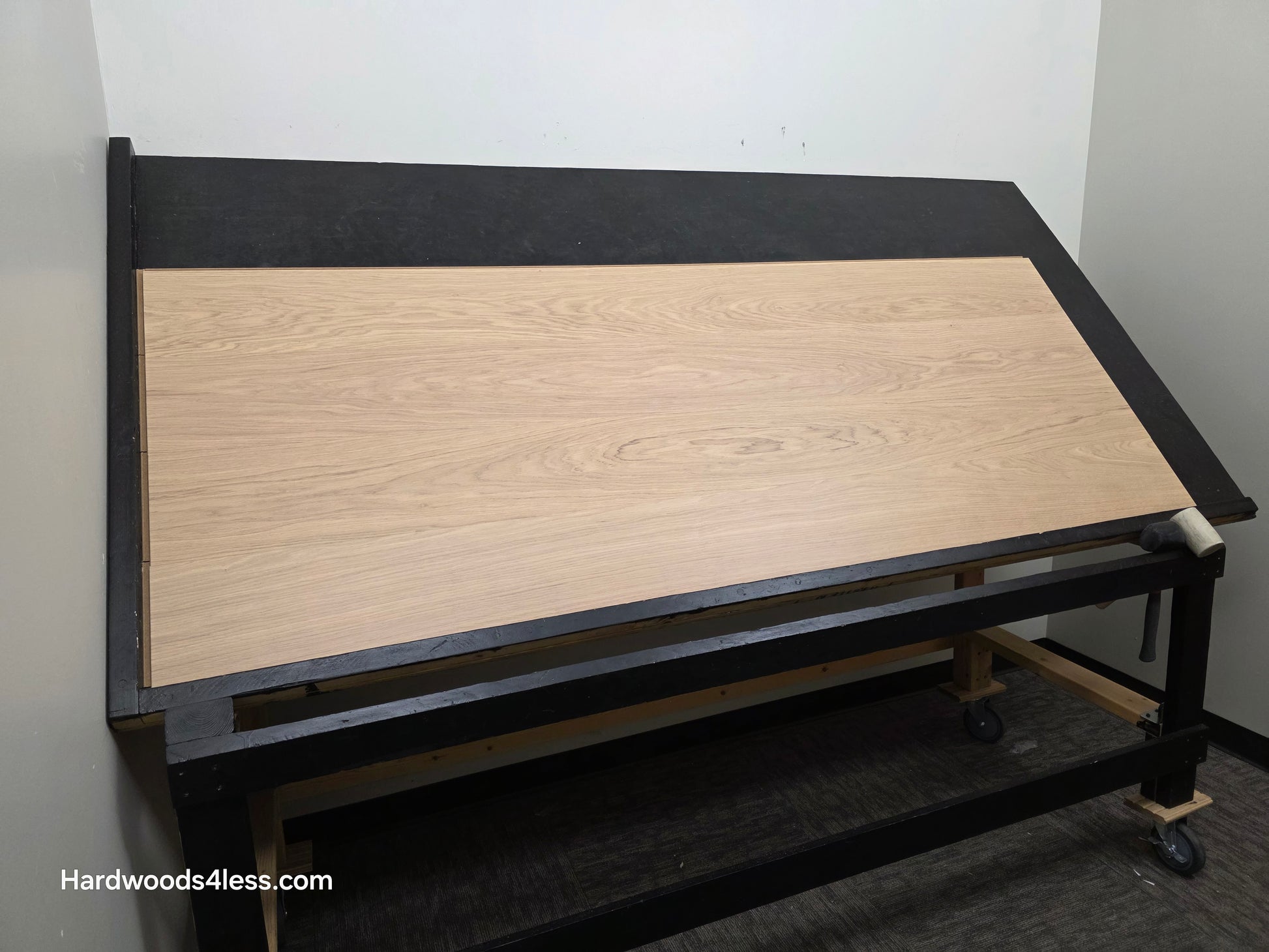 8.11" x 7/16" Modernized Engineered European Oak Gropius Hardened Hardwood Flooring. Shown on a black shooting table. Shot from wide left. 