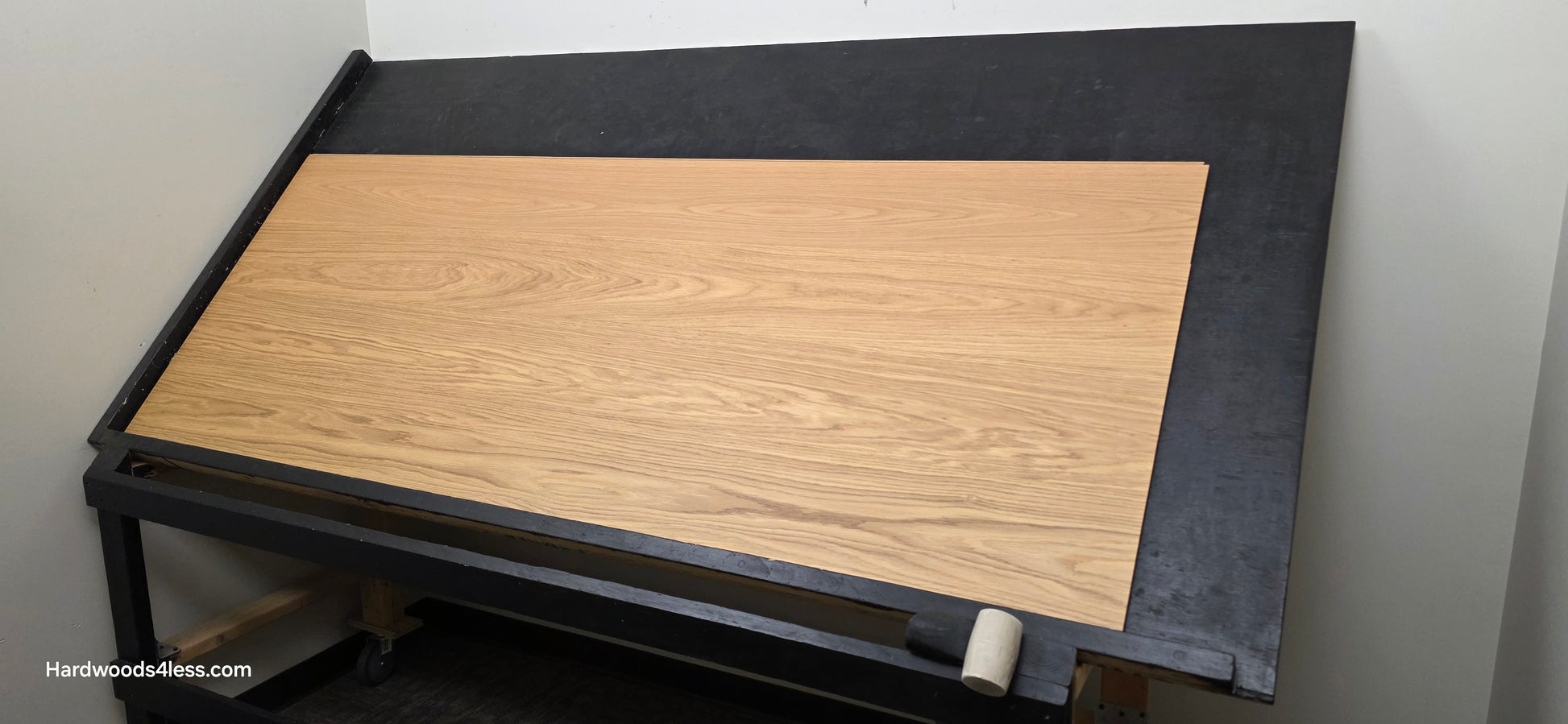 8.11" x 7/16" Modernized Engineered European Oak Hadid Hardened Hardwood Flooring. Shown on a black shooting table. Shot from wide right.