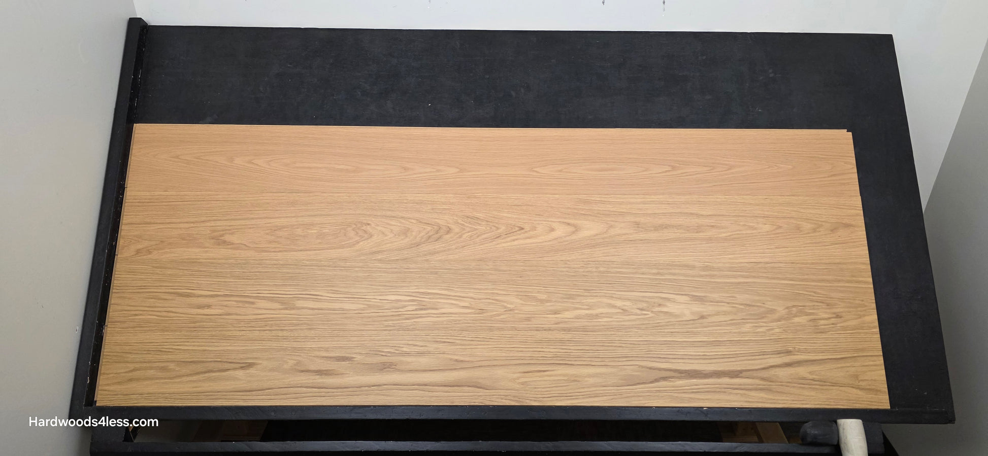 8.11" x 7/16" Modernized Engineered European Oak Hadid Hardened Hardwood Flooring. Shown on a black shooting table. Shot from center.