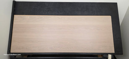 8.11" x 7/16" Modernized Engineered European Oak Foster Hardened Hardwood Flooring. Shown on a black shooting table. Shot from center.