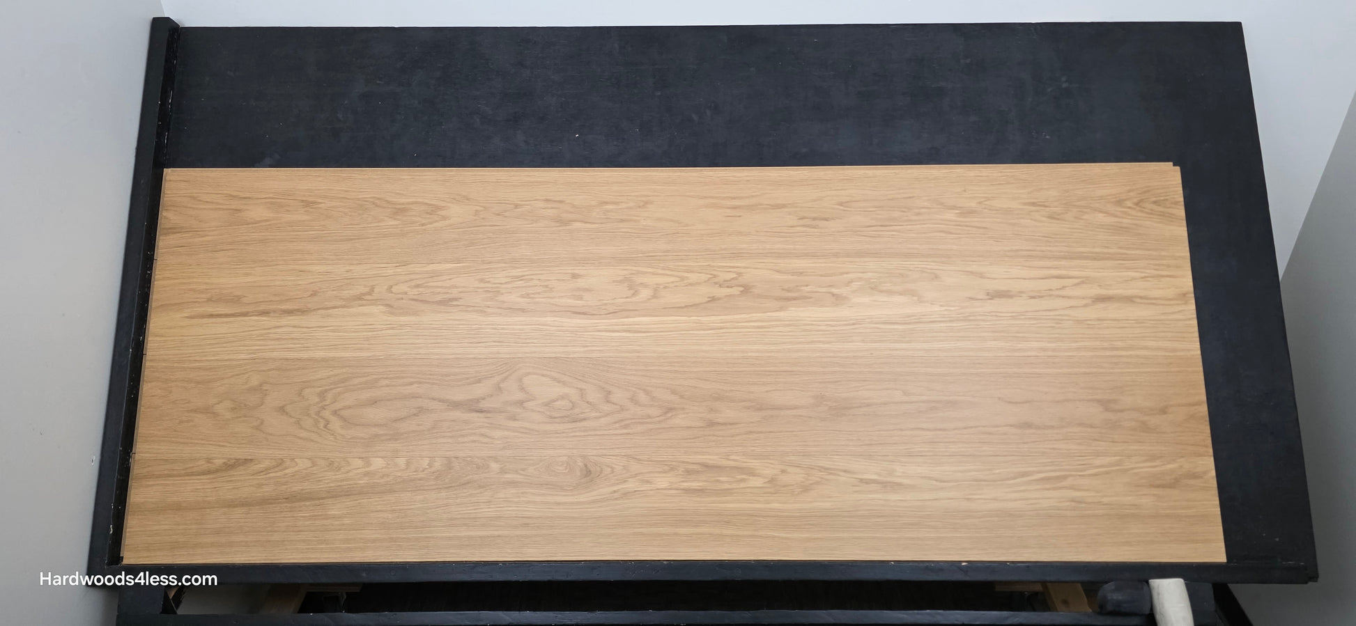 8.11" x 7/16" Modernized Engineered European Oak Wright Hardened Hardwood Flooring. Shown on a black shooting table. Shot from center.