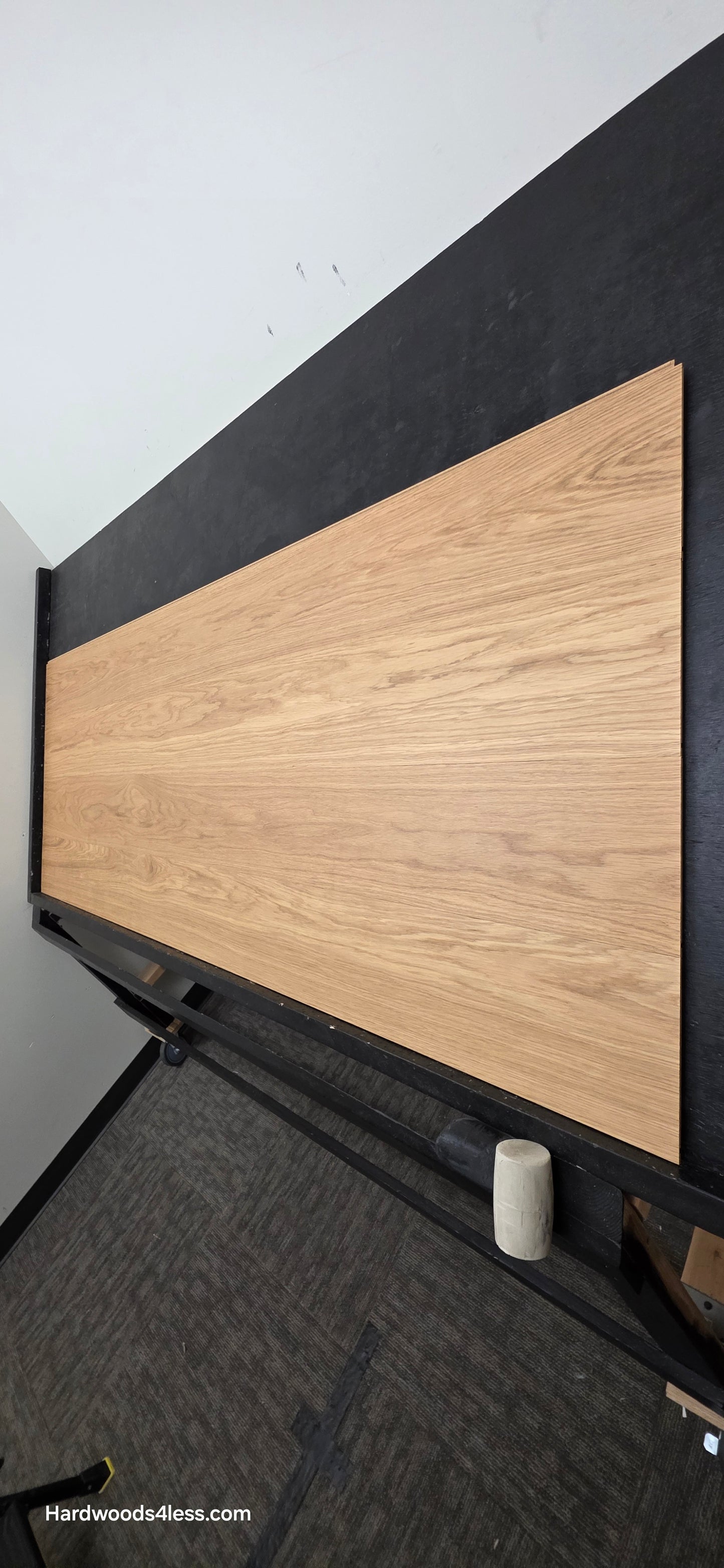 8.11" x 7/16" Modernized Engineered European Oak Wright Hardened Hardwood Flooring. Shown on a black shooting table. Shot from steep right.