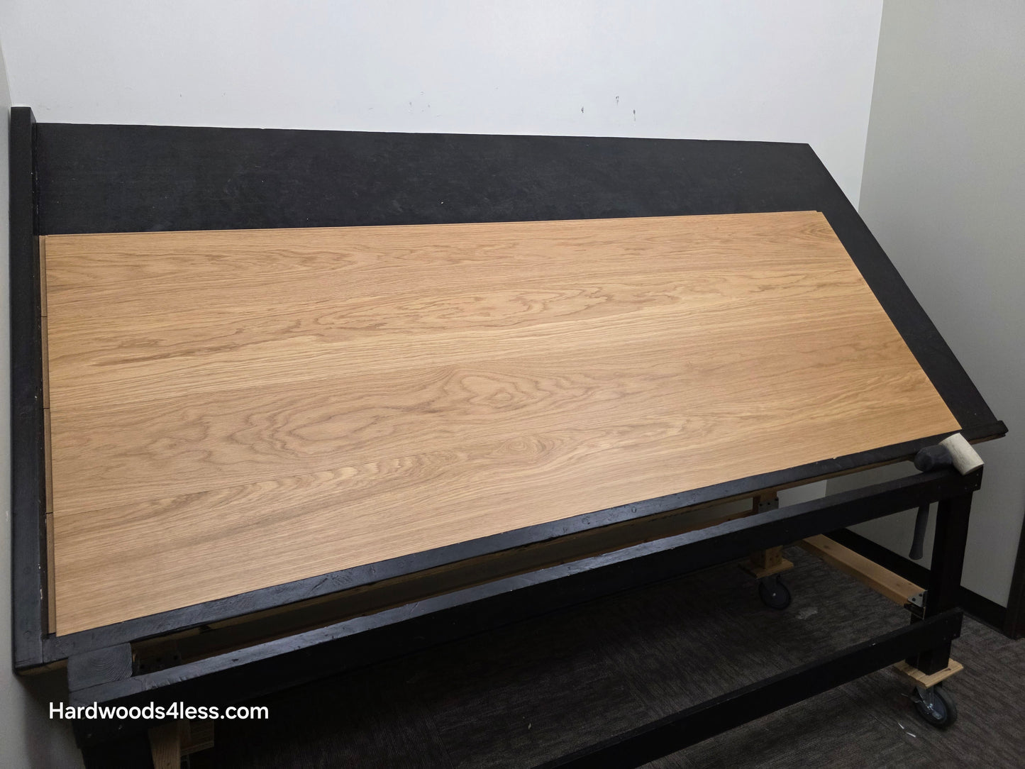8.11" x 7/16" Modernized Engineered European Oak Wright Hardened Hardwood Flooring. Shown on a black shooting table. Shot from wide left.